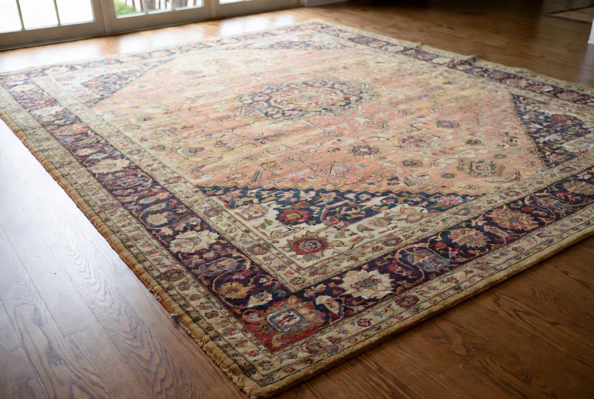 Antique wool oriental area rug on a hardwood floor